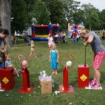 Adults battling on the balloon blaster arcade game