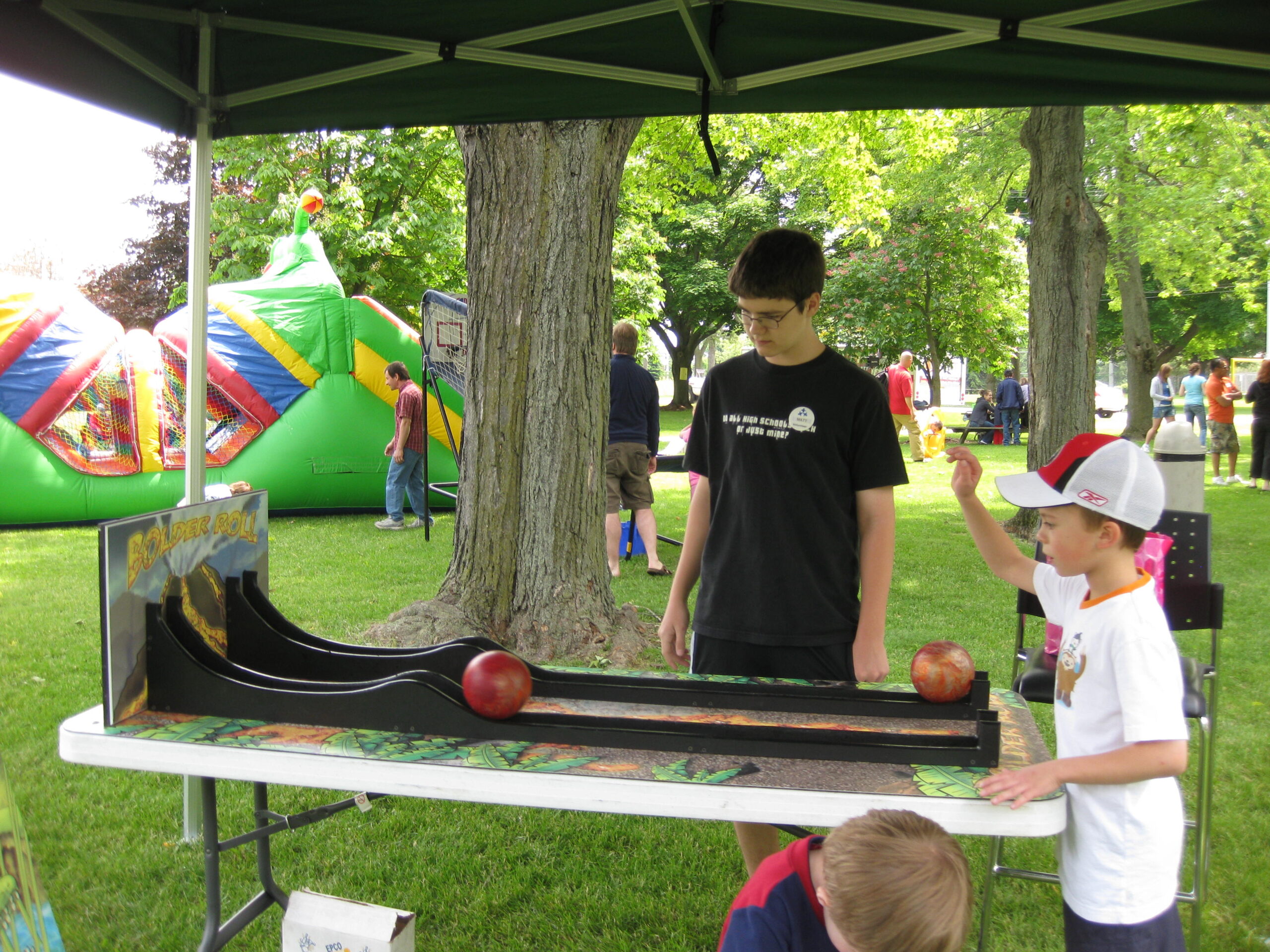 Child playing the boller roller arcade game at outdoor event