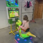 Interactive Dino Rider arcade game available for rent